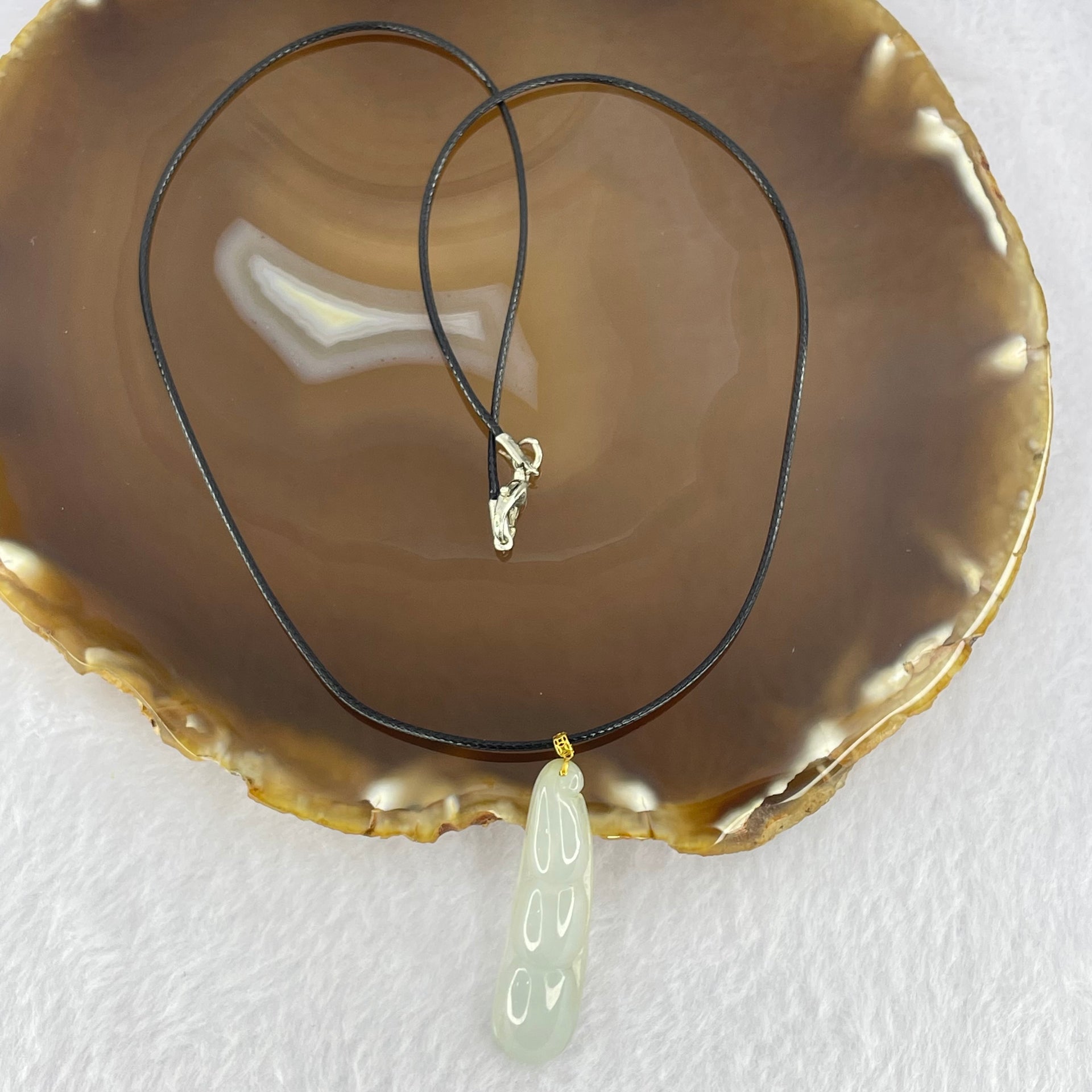 Type A Faint Green Jadeite Peapod Pendent 6.17g 39.1 by 11.3 by 7.1mm - Huangs Jadeite and Jewelry Pte Ltd